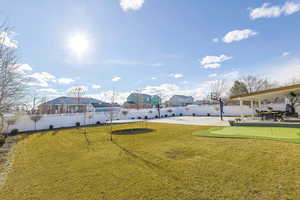 View of yard featuring a patio and a trampoline