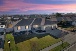 View of front of home featuring a garage and a yard