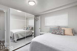 Bedroom with wood-type flooring and a textured ceiling