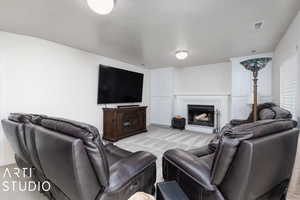 Carpeted living room featuring a textured ceiling