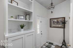 Foyer entrance with wood-type flooring