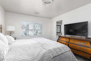 Bedroom featuring a textured ceiling and ensuite bath