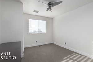 Carpeted empty room with ceiling fan