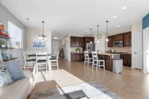 Tiled living room featuring a notable chandelier