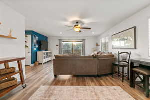 Living room with hardwood / wood-style floors and ceiling fan