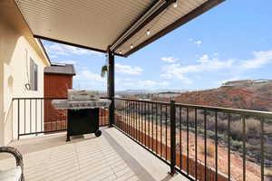 Balcony featuring a mountain view and grilling area