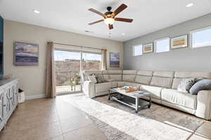 Tiled living room featuring ceiling fan