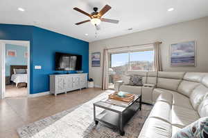 Living room with tile patterned flooring and ceiling fan