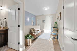 Hall featuring light tile patterned floors