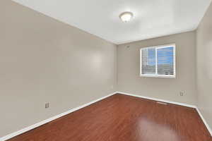 Empty room featuring wood-type flooring