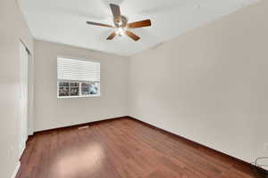 Unfurnished room featuring ceiling fan and wood-type flooring