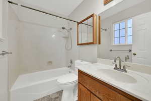 Full bathroom with vanity, shower / tub combination, and toilet