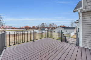 Wooden deck with a mountain view and a lawn