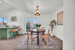 Dining room featuring a wealth of natural light, french doors, tile wood-style flooring