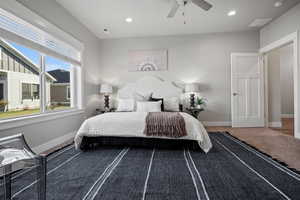 Carpeted bedroom with ceiling fan