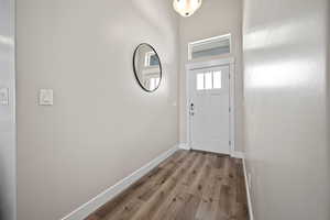 Doorway with light hardwood / wood-style flooring