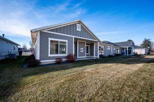 View of front of house featuring central air condition unit and a front lawn