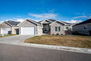 View of front of home with a front yard and a garage