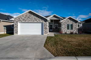 View of front of home with a garage and a front yard