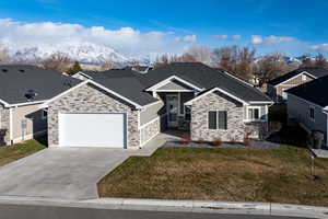 View of front of home with a front yard and a garage