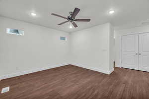 Interior space featuring ceiling fan and dark wood-type flooring