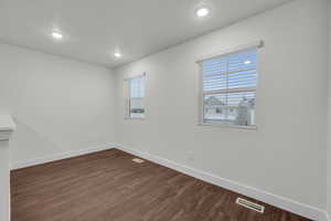 Spare room with dark hardwood / wood-style flooring