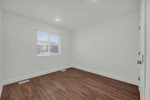 Unfurnished room with dark hardwood / wood-style floors