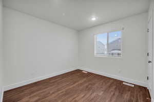 Empty room featuring hardwood / wood-style flooring