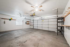 Garage with ceiling fan and a garage door opener