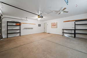 Garage featuring a garage door opener and ceiling fan