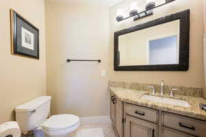 Bathroom with tile patterned floors, vanity, and toilet