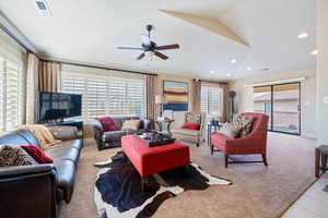 Living room with vaulted ceiling and ceiling fan