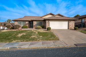 View of front of home with a garage and a front yard