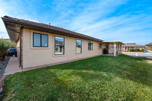 Back of house featuring a lawn