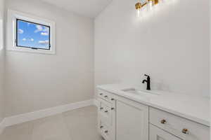 Bathroom featuring tile patterned floors and vanity