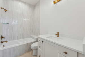 Bathroom featuring tile patterned floors, vanity, and toilet