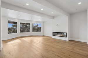 Basement Family room with plenty of natural light and light wood-type flooring