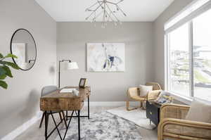 Office space with a healthy amount of sunlight, a chandelier, and light wood-type flooring