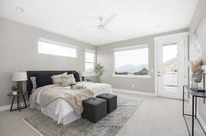 Bedroom with access to exterior, light colored carpet, and ceiling fan