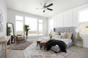 Carpeted bedroom featuring ceiling fan