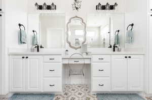 Bathroom featuring vanity and a shower