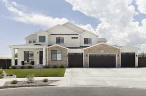 View of front of house with covered porch and a front yard