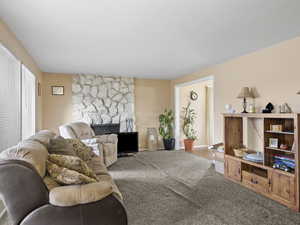 Living room with a fireplace and carpet floors