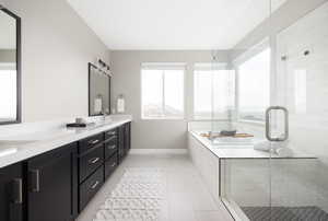 Bathroom with plus walk in shower, vanity, and tile patterned floors