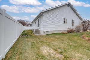 View of home's exterior with a yard