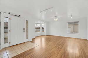 Entryway with light wood-style flooring and ceiling fan