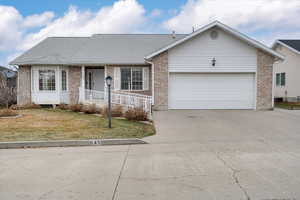 Single story home with a front lawn and a garage