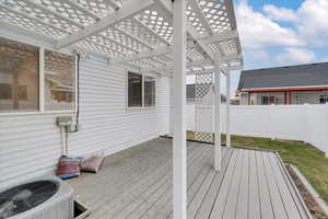 Deck featuring a pergola and central AC