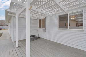 Deck with a pergola and central AC unit