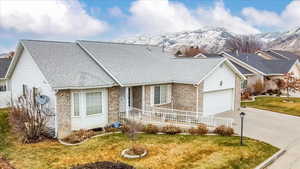 Single story home with a front lawn and a garage